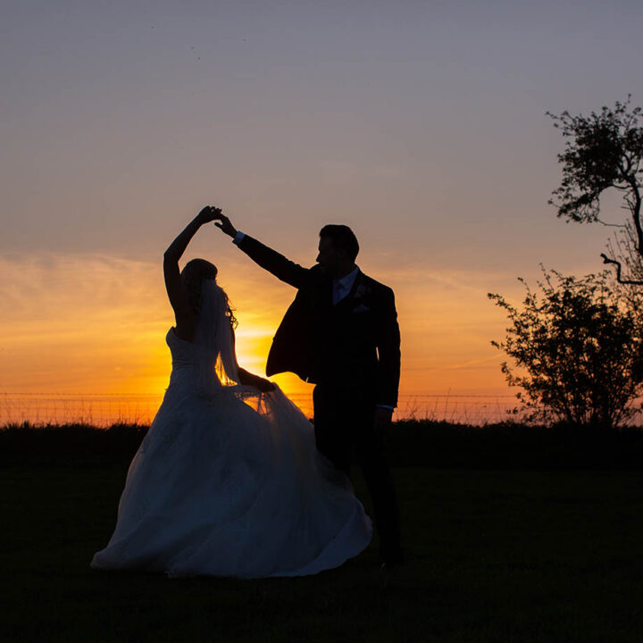 wedding couple dancing in sunset